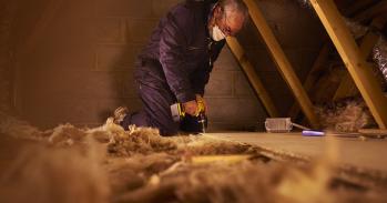 Man installing loft insulation