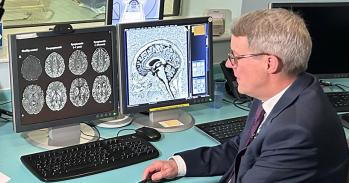 Patrick Chinnery looks at brain scans on a computer screen
