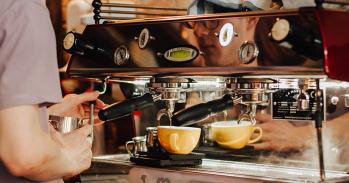 Person using an espresso machine
