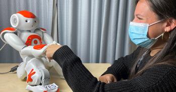 Robot shaking hands with Dr Micol Spitale