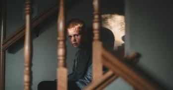 Angry boy on stairs 