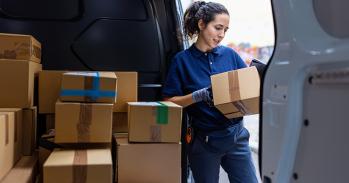 Courier checking parcel for delivery