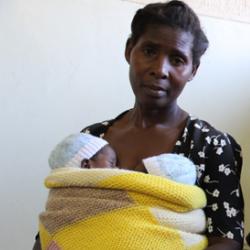 Suffering from pre-eclampsia, this young mother had to undergo a Caesarean to deliver her twin boys, seen here in the arms of her mother (Malawi)