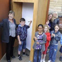 Diana Bell and Cambridge school children with the Big Book outside Cambridge University Library