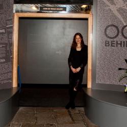 Dr Gilly Carr at the entrance to “Occupied Behind Barbed Wire”, which will be on display in Jersey until the end of 2012.