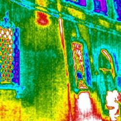 Thermal image of two people standing outside a building. The study found that in many European countries, including the UK, predicted energy usage in homes bears little resemblance to the amount used in practice.