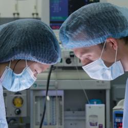 Two researchers wearing masks in operating theatre