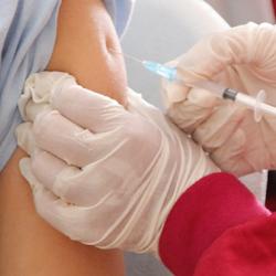 Close up of a person being injected with a vaccine