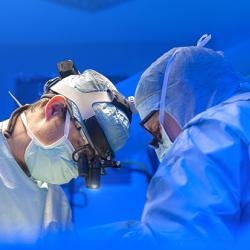Surgeons performing heart surgery