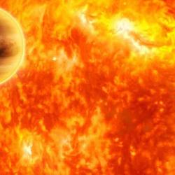 This artist's impression shows a gas-giant exoplanet transiting across the face of its star. Infrared analysis by NASA's Spitzer Space Telescope.