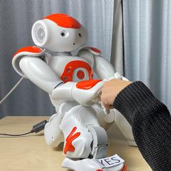 Robot shaking hands with Dr Micol Spitale
