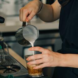 A barista making a coffee
