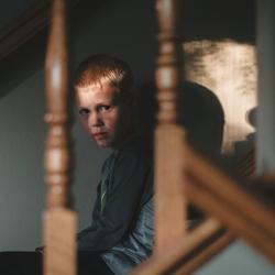 Angry boy on stairs 
