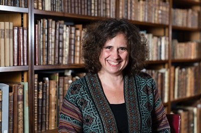 Pro-Vice Chancellor, Professor Anne Ferguson-Smith behind a bookshelf filled with books
